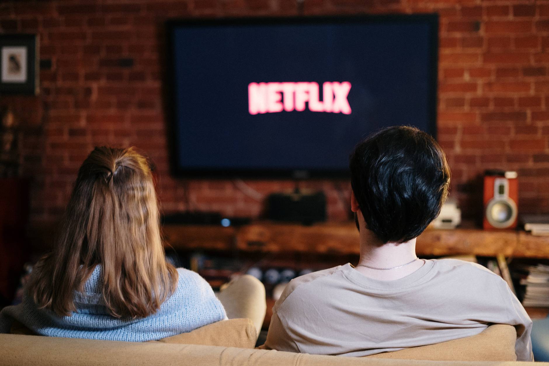 couple with Netflix pulled up on their TV